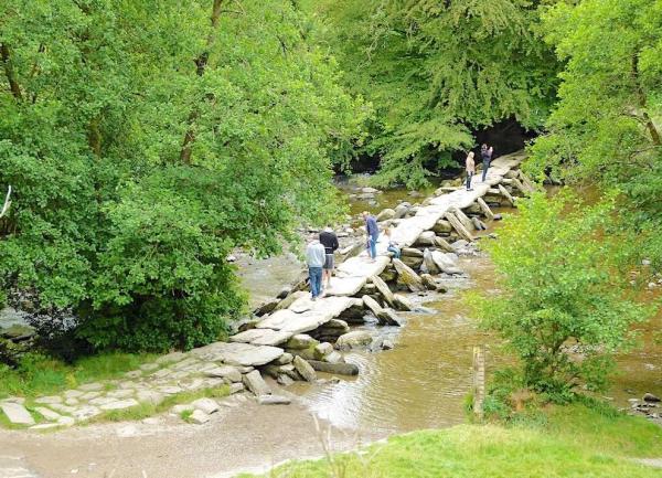 Tarr Steps, a prehistoric clapper bridge, crosses the |River Barle on Exmoor.