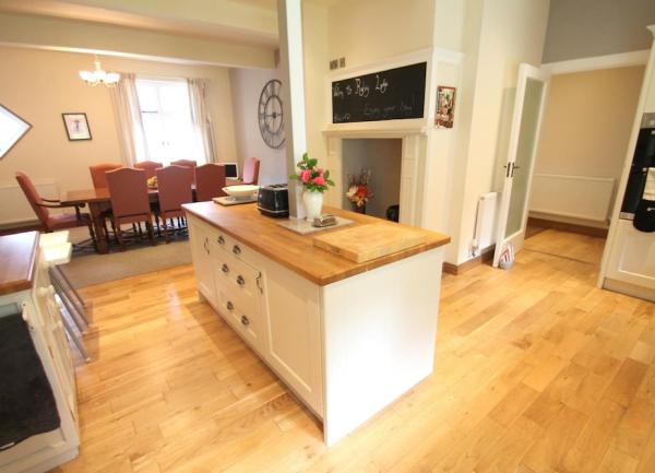 A kitchen island block with a dining room beyond.