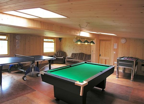 Games room with a pool table, table tennis and football table.