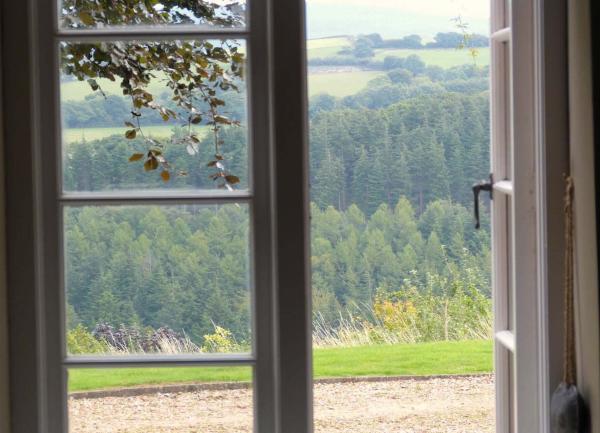 Views of Exmoor countryside through open lounge French windows.