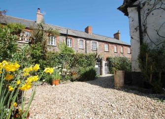 A terrace of Somerset cottages and front gardens.