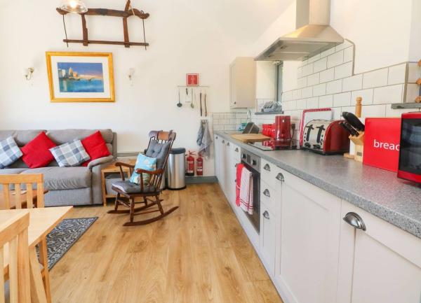 Fitted kitchen units with kitchen appliances on the worktop.