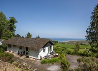 A modern bungalow in an elevated remote rural location wit sea views. 