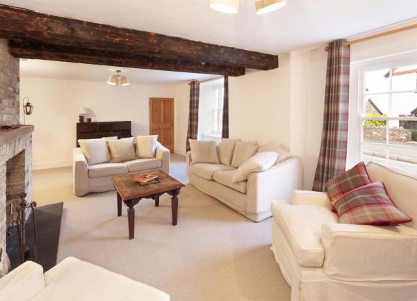 Lounge in a large holiday cottage in Porlock with 3 sofas, armchair and coffee table.