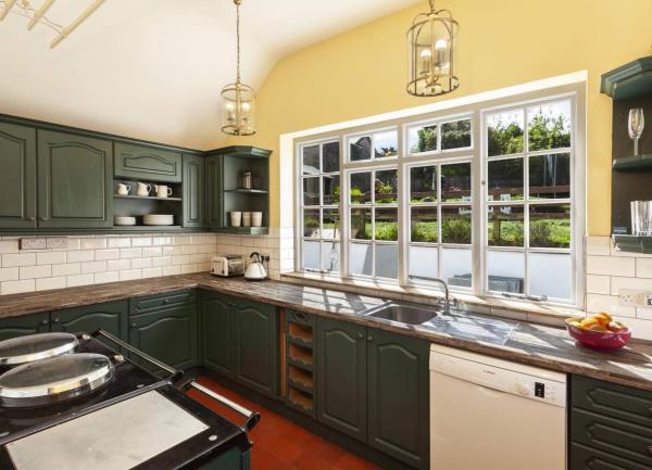 A fitted kitchen with integrated appliances including an AGA and dishwasher.