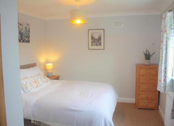 Exmoor cottage double bedroom with bed and bedside lights.