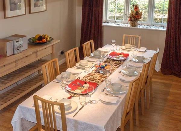A large dining table laid for a high tea.