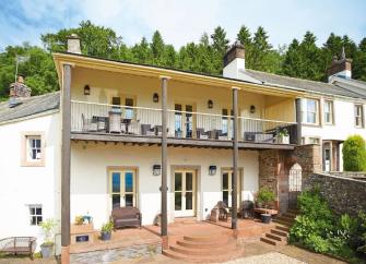 Ulleswater holiday cottage with a full length balcony and front terrace.