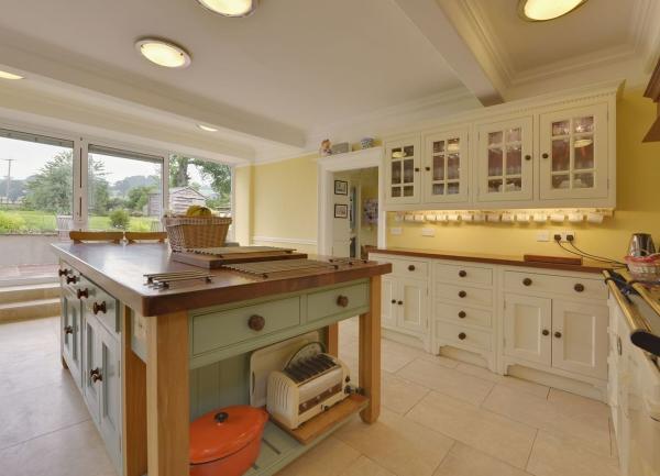 Luxuriously furnished kitchen with fitted floor and wall units and a big butchers block