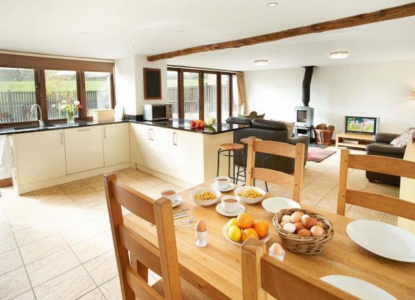 Wooden dining table and chairs opposite the kitchen area.
