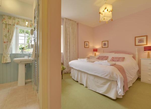 View through 2 doors to a double bedroom and bathroom. Double bedroom