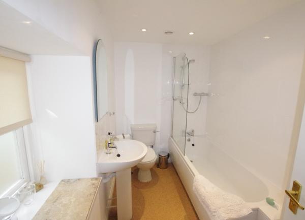 Family bathroom with a bath/hower, washbasin and WC.