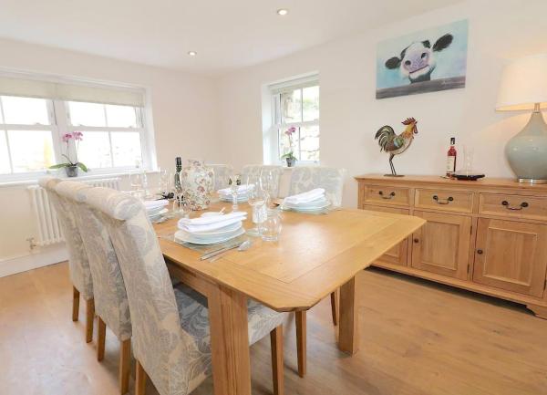 A dininr room with a table seating 8 and sideboard.
