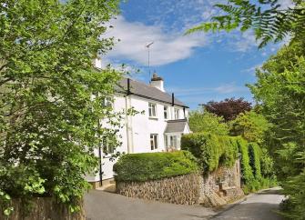 A country cottage in an elevated position overlooks a quiet country lane in North Devon.