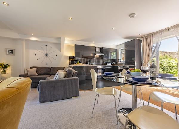 A luxuriously-furnished lounge diner with French windows to a garden.