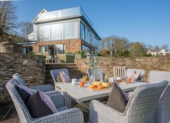 Luxury holiday home with 1st floor being all windows with a roof terrace above.