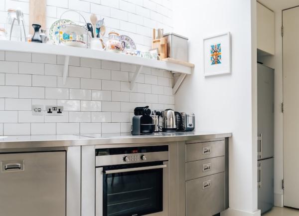 A tiled, fitted kitchen with electric oven.