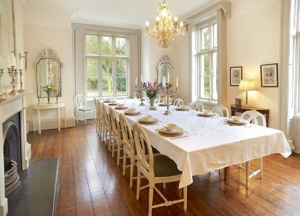 A grand dining room with a long table seating 26.
