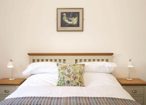 Double bedroom with bedside cabinets and table lamps.