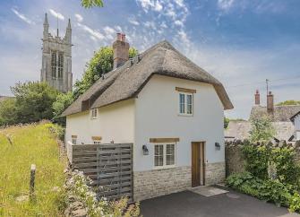 Exterior of a thatched village cottage in Dorset.