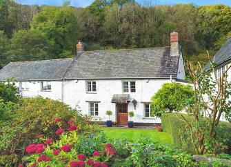 A large old mill cottage nestles in a wooded Exmoor valley.
