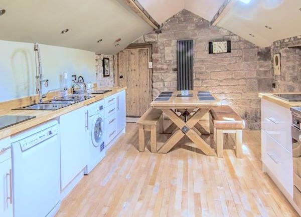 A well-equipped, upmarket kitchen with dishwasher, washing machine and a breakfast table seating 6.