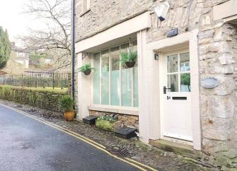 Exterior of a stone-built end-of-terrace Dales cottage