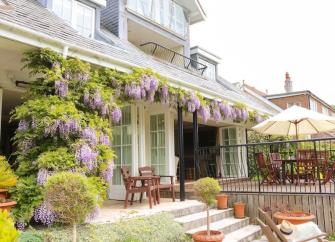 Wisteria-clad exterior of a Luxury waterside holiday home.