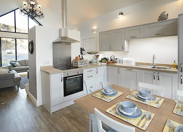 A kitchen-diner with electric cooker and full-height fridge-freezer.