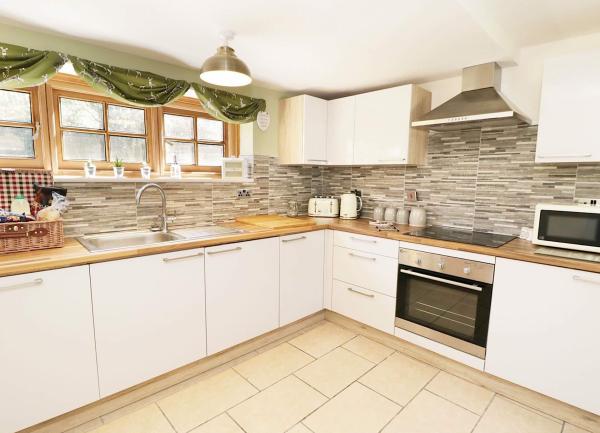 Dales country coottage kitchen with exposed stone walls and contemporary fitted units.