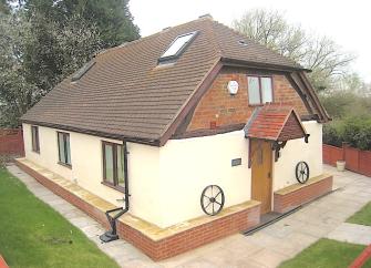 2-storey chalet bungalow surrounded by a garden.