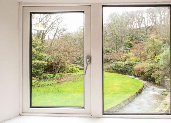   A view of a garden lawn through a bedroom window.