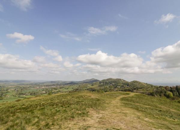 A footpath on the heather-covered crest of The Malvern Hills.