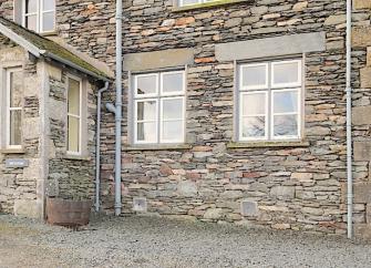 Exterior of a stone-built holiday cottage in the Lake District.