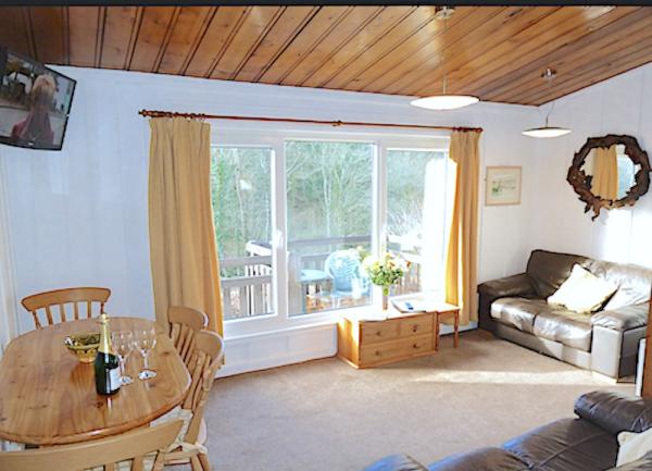 A lounge with twin sofas, large windows and a dining table for six.