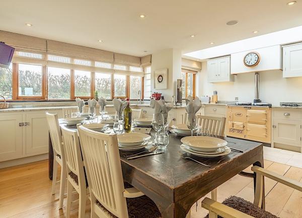 Large kitchen-diner with an Aga stove and dining table.