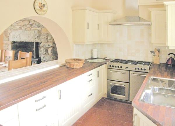 Kitchen with a modern gas oven and two sides of worktops. 