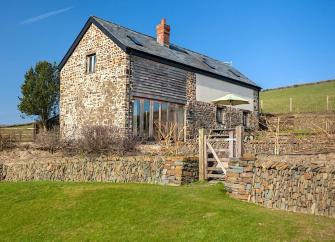 A stone-built Exmoor barn conversion in open countryside.