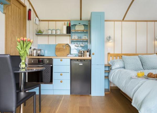 Dining, kitchen and sleeping areas in a Hqmpshire Shepherd's hut