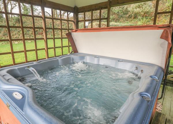 An undercover hot tub with lovely country garden views.