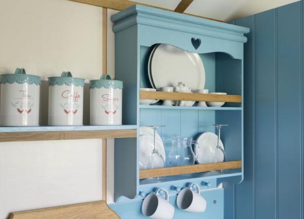 The kitchenette with two of everything in a luxury shepherd's hut.