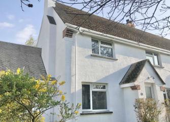 The exterior of a semi-detached, 2-storey Croyde cottage with a covered porch