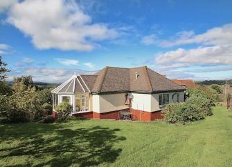 A bungalow surrounded by lawns and open countryside on the West Somerset coast..