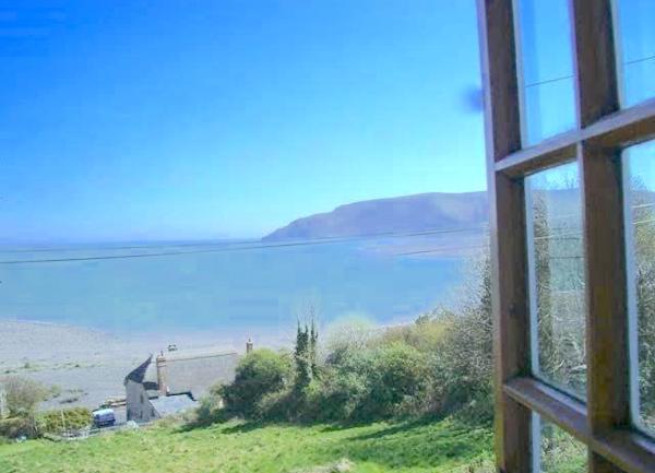 Coast and country views from a bedroom window at The Crows Nest cottage in Porlock Weir.