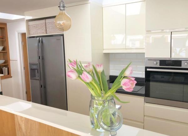 Bespoke kitchen units with a full-height American-style fridge-freezer, oven and a microwave.
