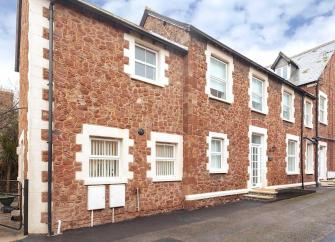 Stone-built terraced Minehead holiday cottage on a quiet village street.