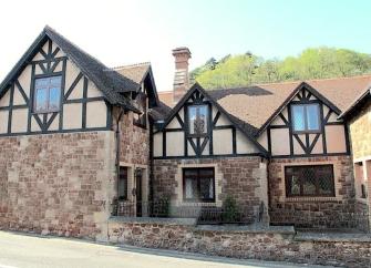 A 2-storey stone-built house overlooks a courtyard.