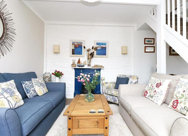 Two sofas face each other over a coffee table in a Mevagissey cottage lounge