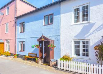 A 2-storey coastal cottage in Watchet with a gabled porch opening onto a village street.
