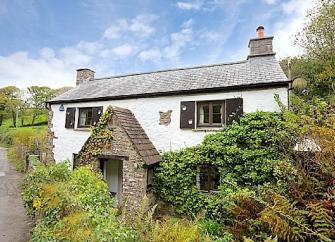 A secluded country cottage with an ivy clad exterior on a quiet country lane.